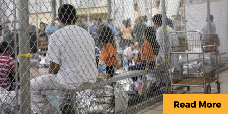 migrants behind fence