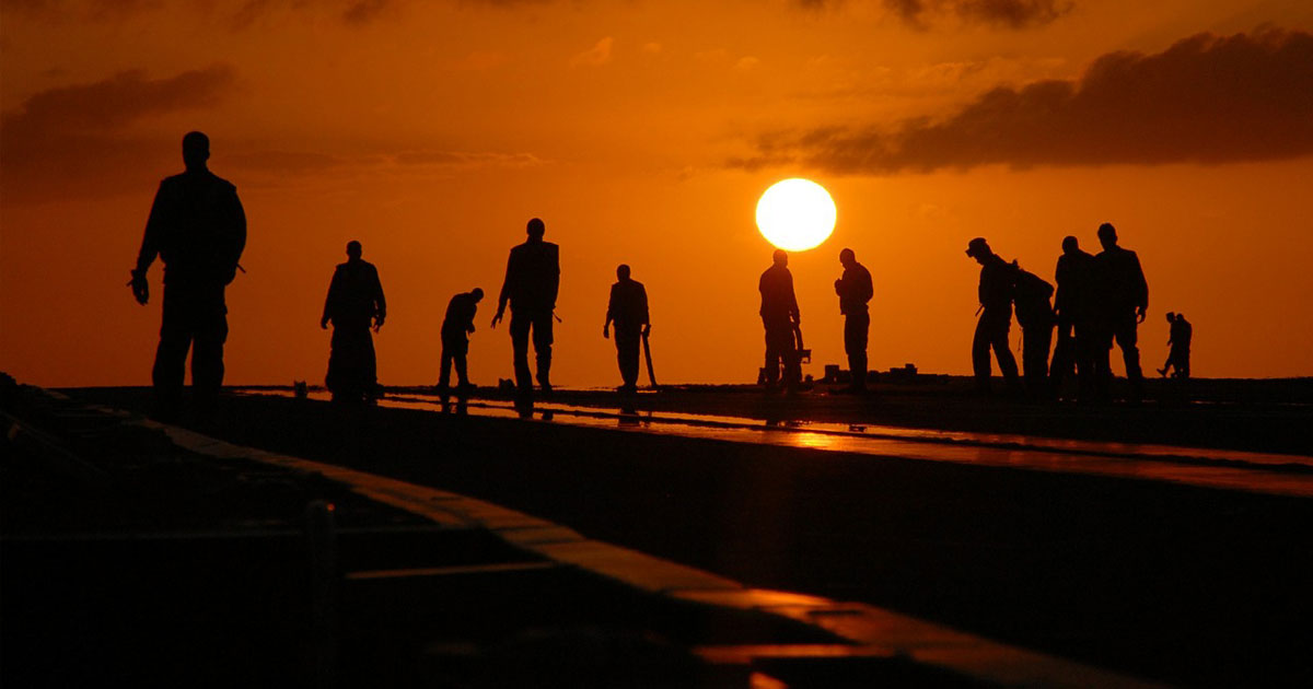 mcn workers in the field at sunset