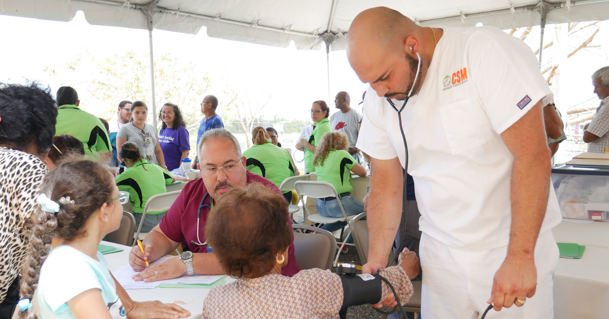 clinician taking woman's blood pressure