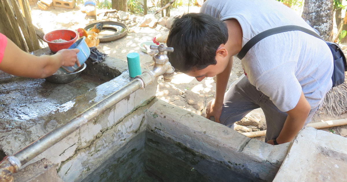 clinician inspects water source