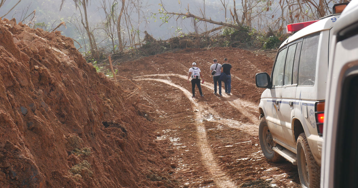 Cars driving on hurricane beaten dirt roads