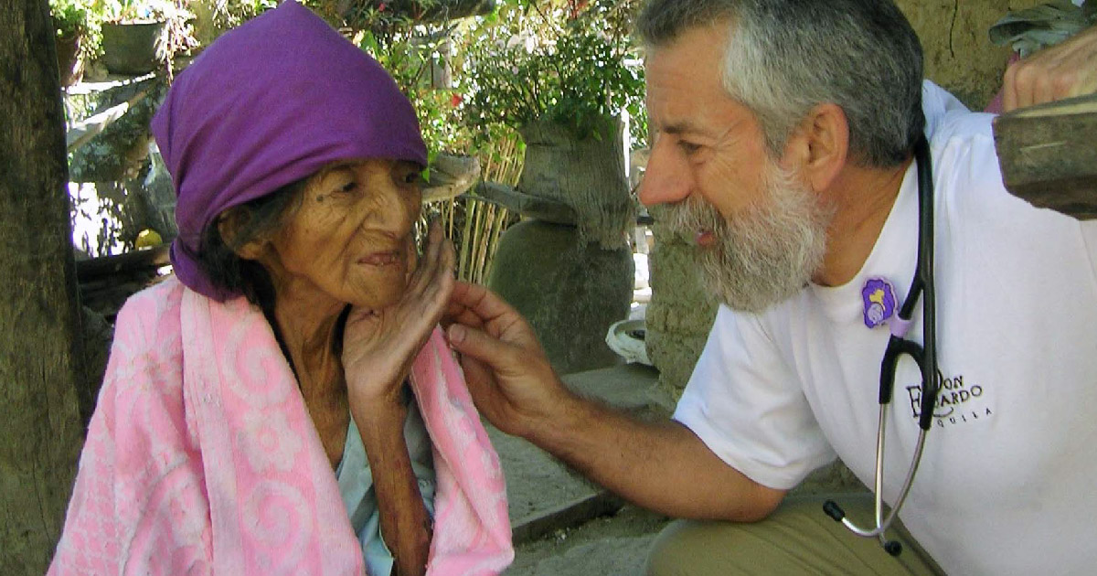 Ed Zuroweste treats elderly woman