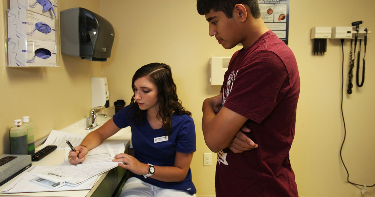 clinician taking notes on patient