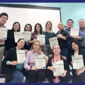 Training of Trainers attendees pose for photo with their certificates.