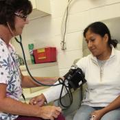 Clinician checks blood pressure of patient