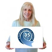 MCN's CEO Karen Mountain holding a 35 year anniversary sign