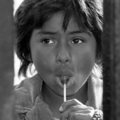 Girl looks through border fence