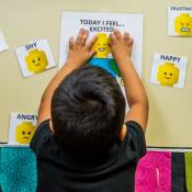 Child choosing faces that represent emotions