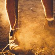 worker standing on dusty soil