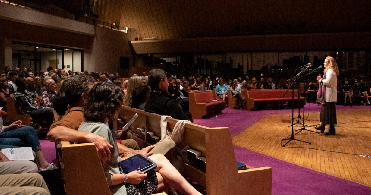 Jill speaking at Voces Fuertes concert