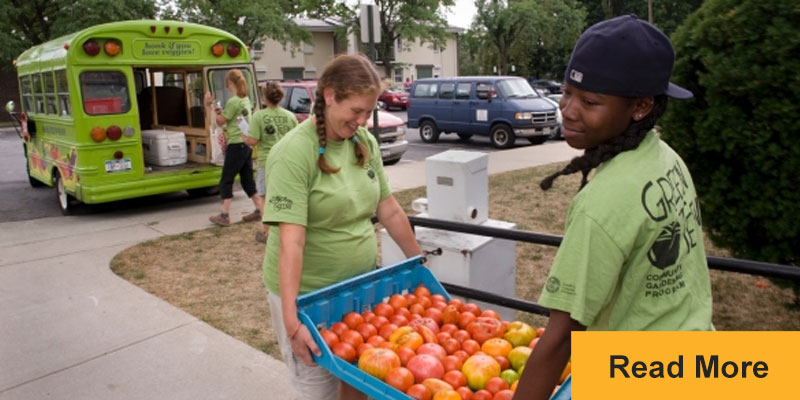 kids carrying bin of tomatoes at school