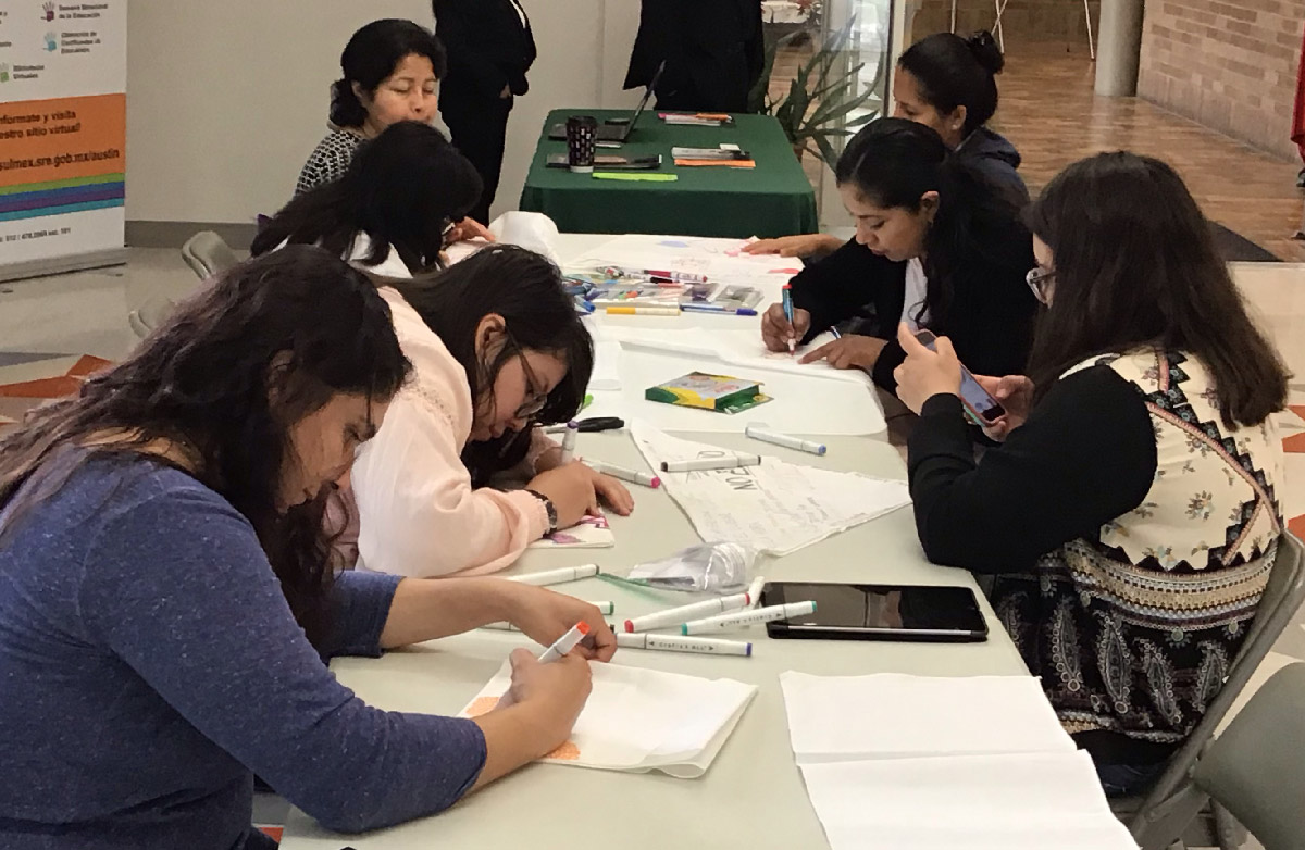 Participants in the bandana project work on their bandanas