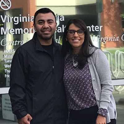 Kevin Alfaro-Martinez and Eva Galvez stand in front of health center.