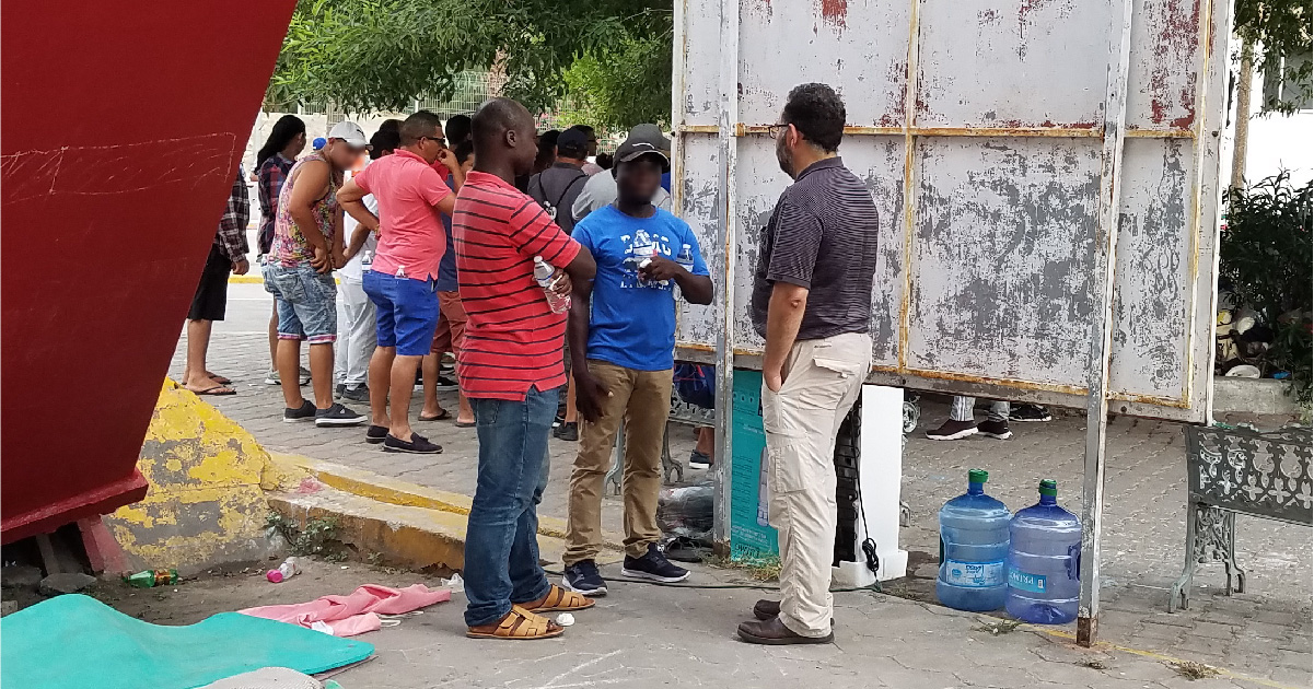 MCN Chief Medical Officer Laszlo Madaras speaking with asylum seekers.