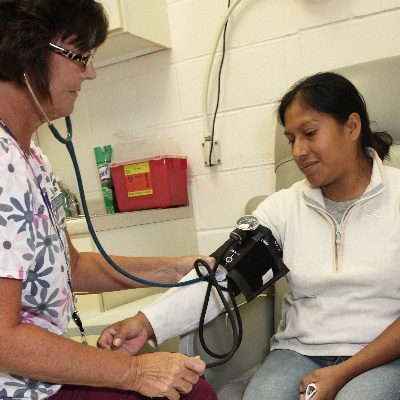 Health Care is a Human Right: MCN’s Statement on Finalized Public Charge Rule Clinician checks blood pressure of patient