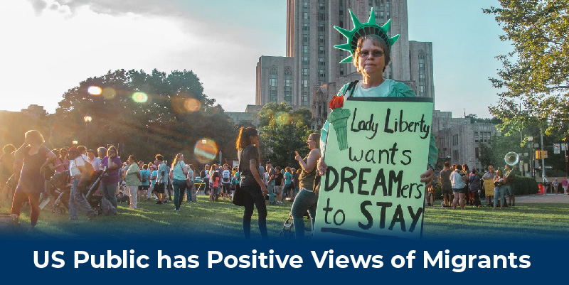 A woman with a sign that reads 'Lady Liberty wants Dreamers to stay'.