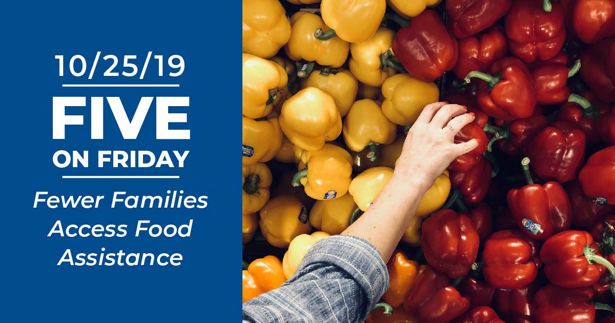 A hand grabs a bell pepper from the store