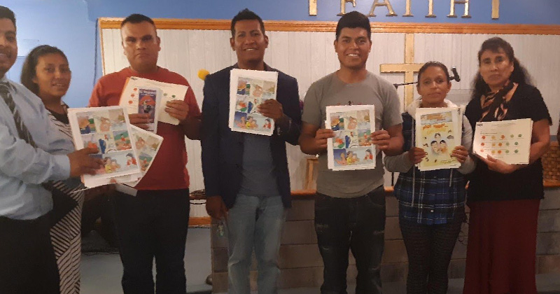 Farmworker parents after participating in an environmental health and safety talk with a community health worker.