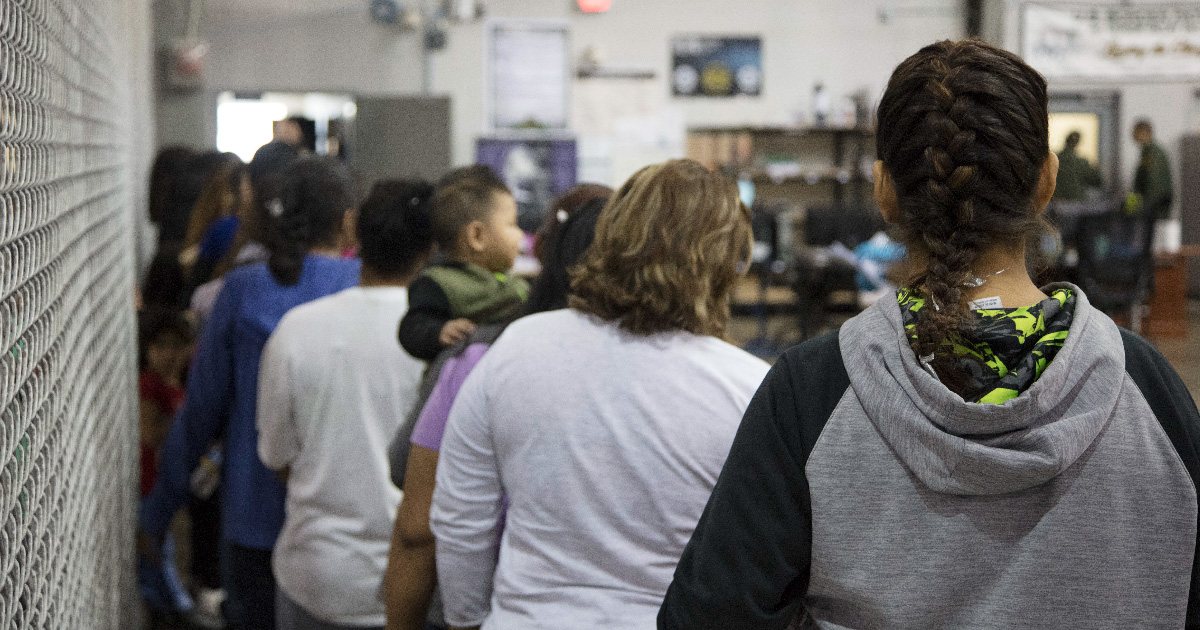 People waiting in line at a detention center