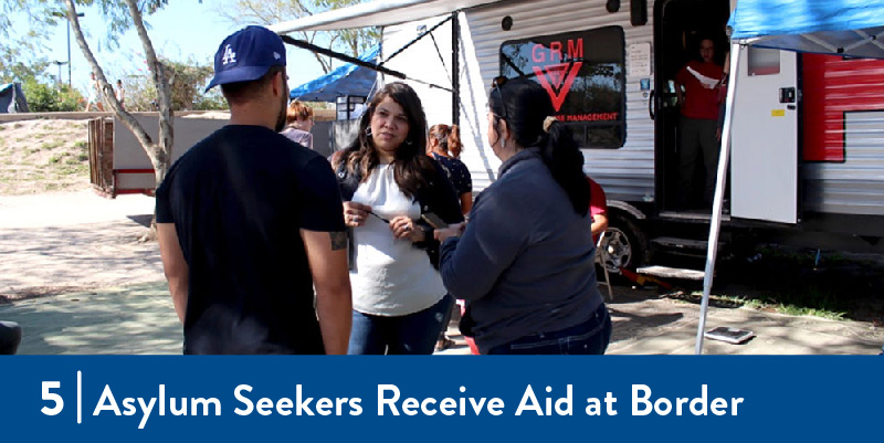 A woman speaks to asylum seekers