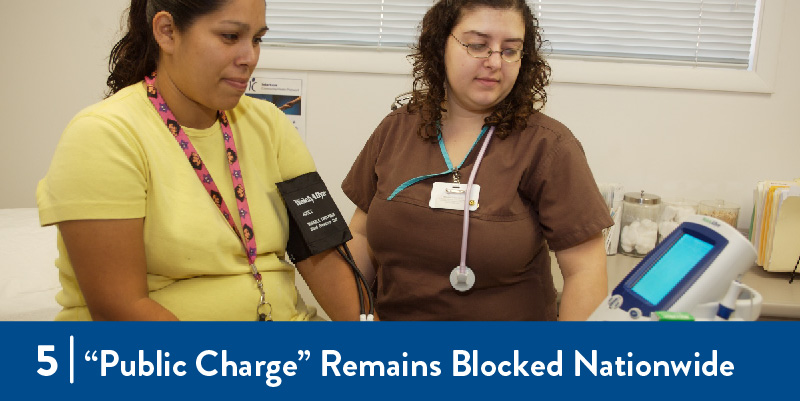 A clinician checks someone's blood pressure