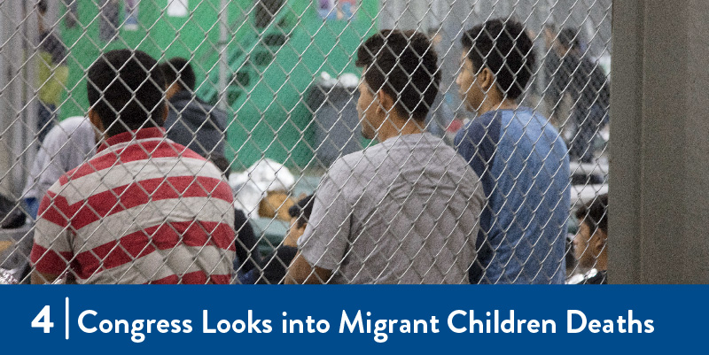 Migrants in sit in a detention center