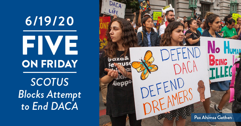 Protesters with signs in support of DACA