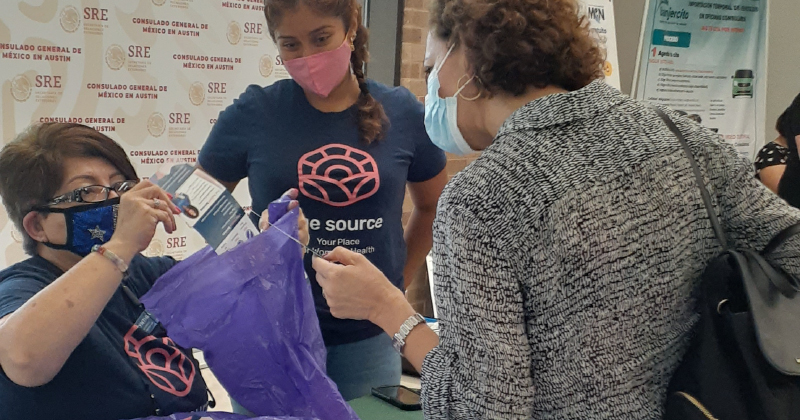 Woman receives materials from informational desk