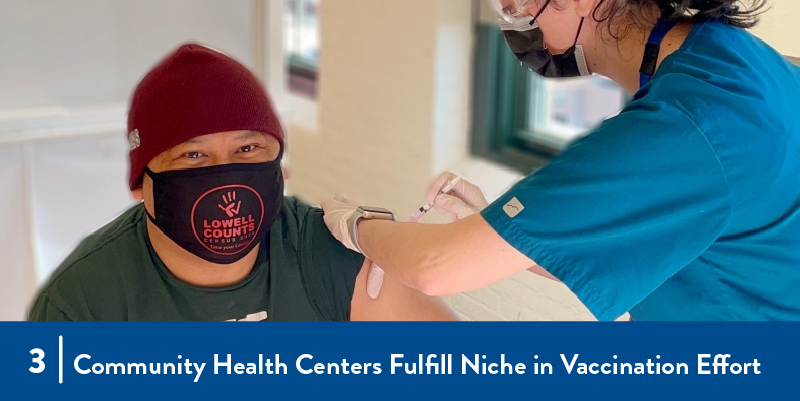 A man receives a vaccination from a clinician