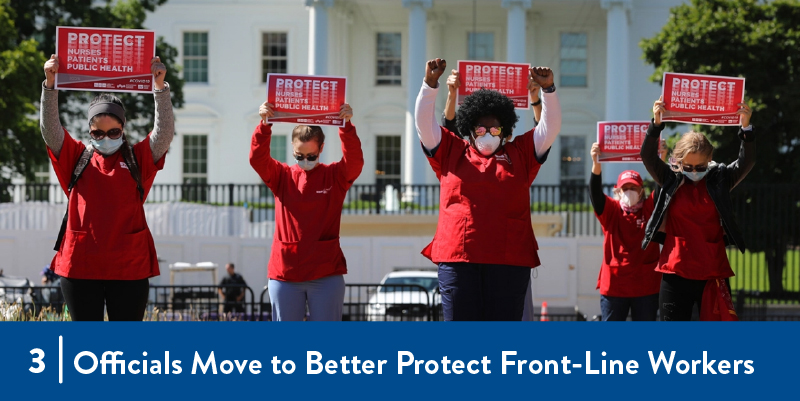 Nurses hold signs