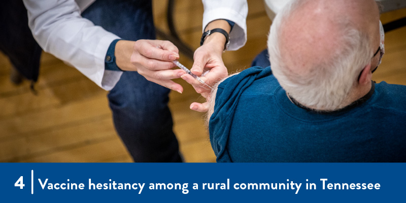 A man receives a vaccination from a clinician