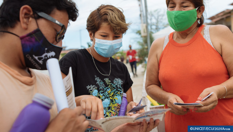 Outreach workers speak with residents of community