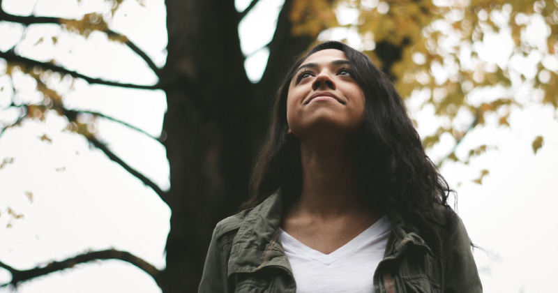 A woman looks to the sky