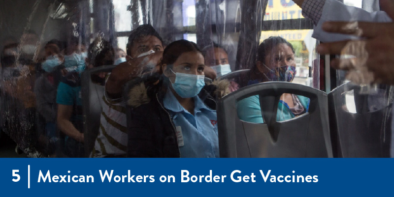 Workers wearing masks on a bus