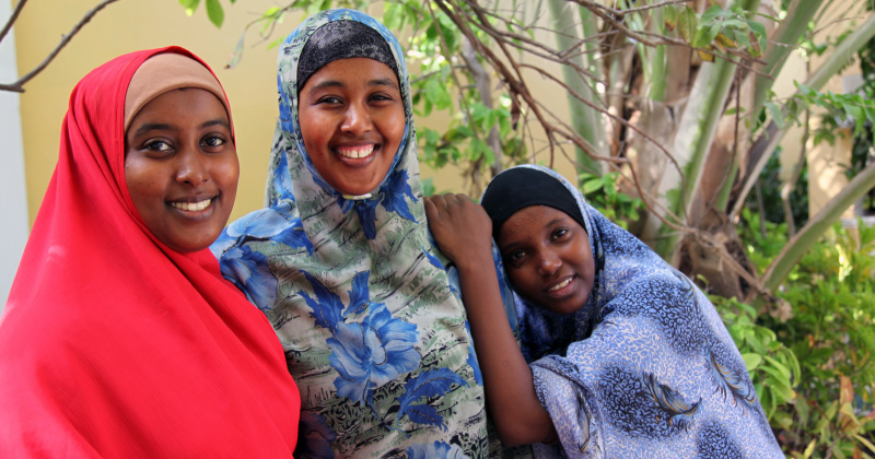 A group of women pose for a photo