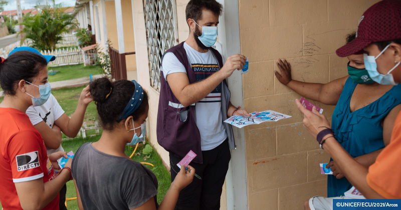 People in masks talk about materials