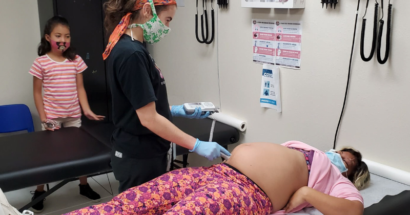 Midwife checks on the health of a mother