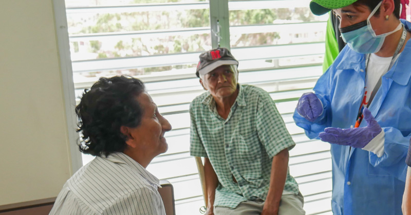 Farmworkers wearing protective gear while working