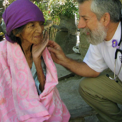 Ed Zuroweste treats elderly woman