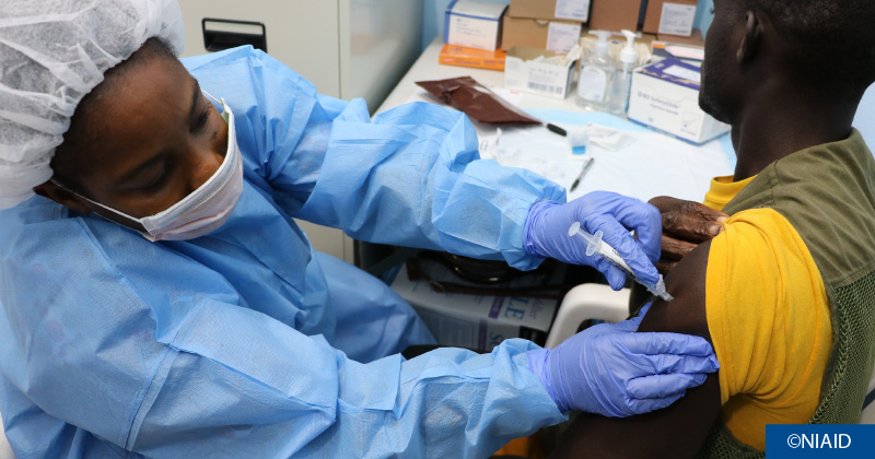 A clinician vaccinates a patient