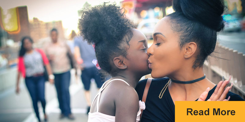 mother and child kissing cheeks