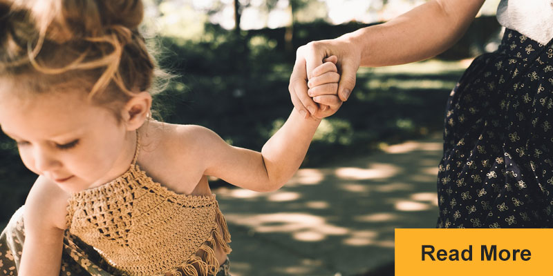 mother holding child's hand