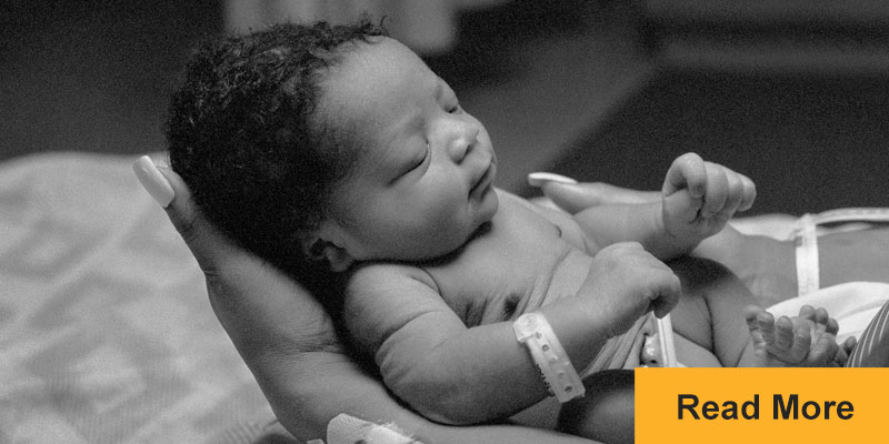 Newborn baby in mother's arms