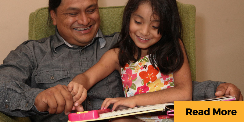 Father and daughter read a book