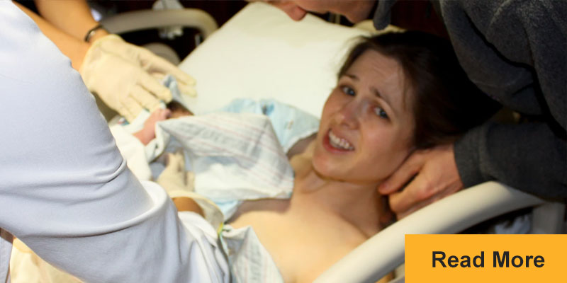 Woman on hospital bed looking distressed