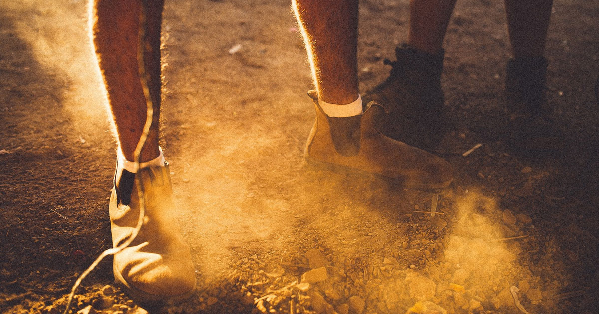 Workers standing on dusty soil