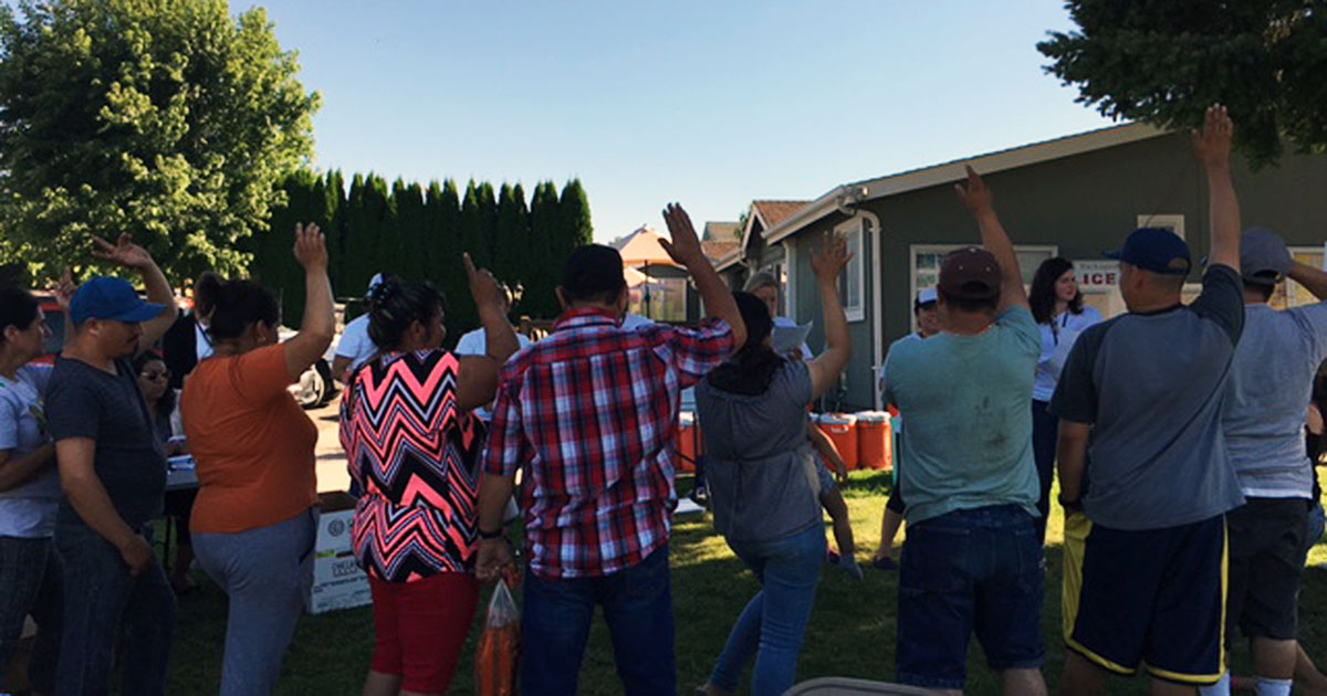 workers raising hands